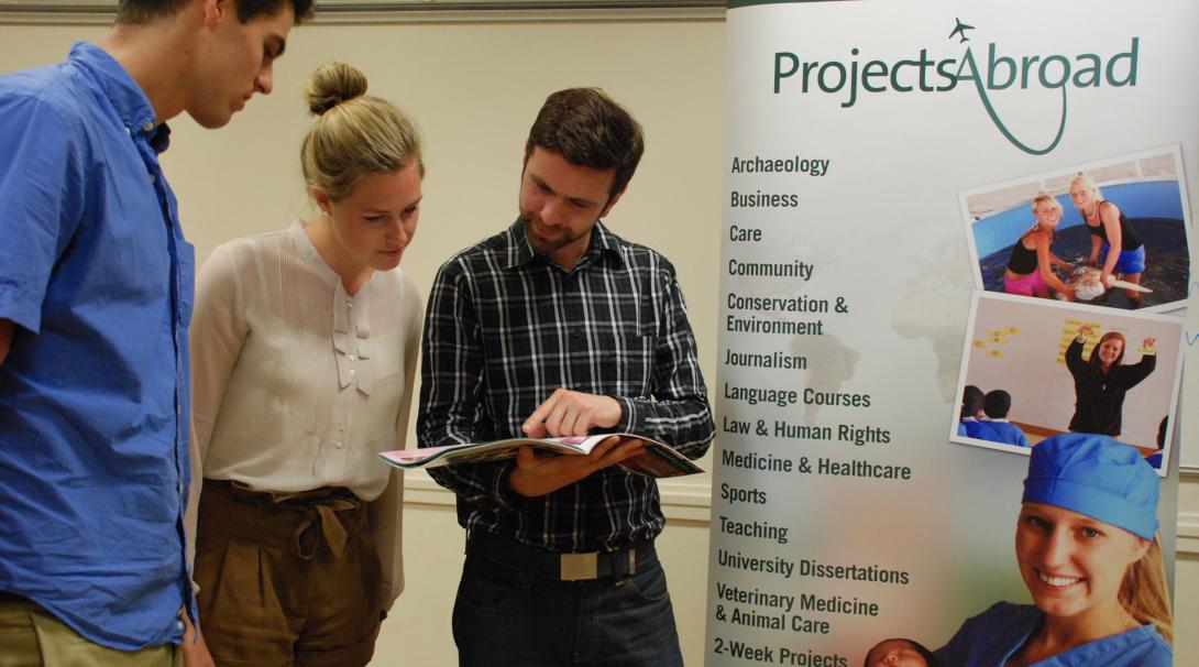 Leads have the volunteer projects and internships explained during an event. Projects Abroad staff talk to potential volunteers during an information event in the UK.